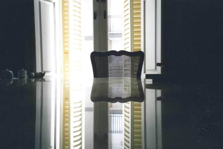 A person pulling a dusty HVAC filter out of a home air vent.