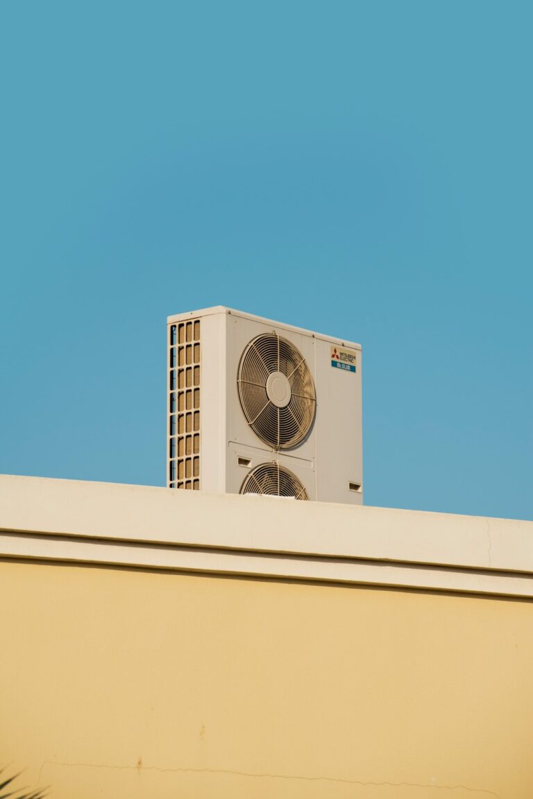 Homeowner checking a vent and thermostat in a living room, with visible concern about cooling performance.